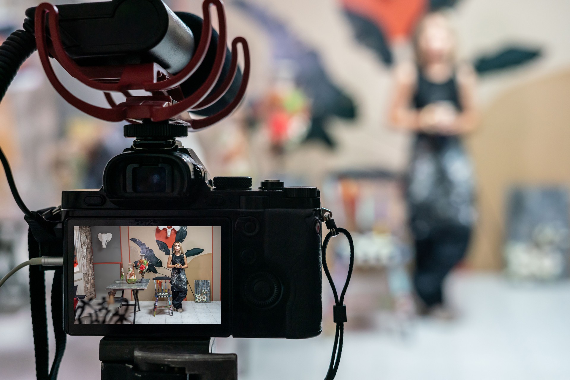video camera is recording to woman artist camera is foreground focus on foreground horizontal still